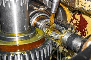 Engineer inspecting industrial machinery to demonstrate how premium industrial lubricants reduce equipment wear, maintenance costs and downtime.